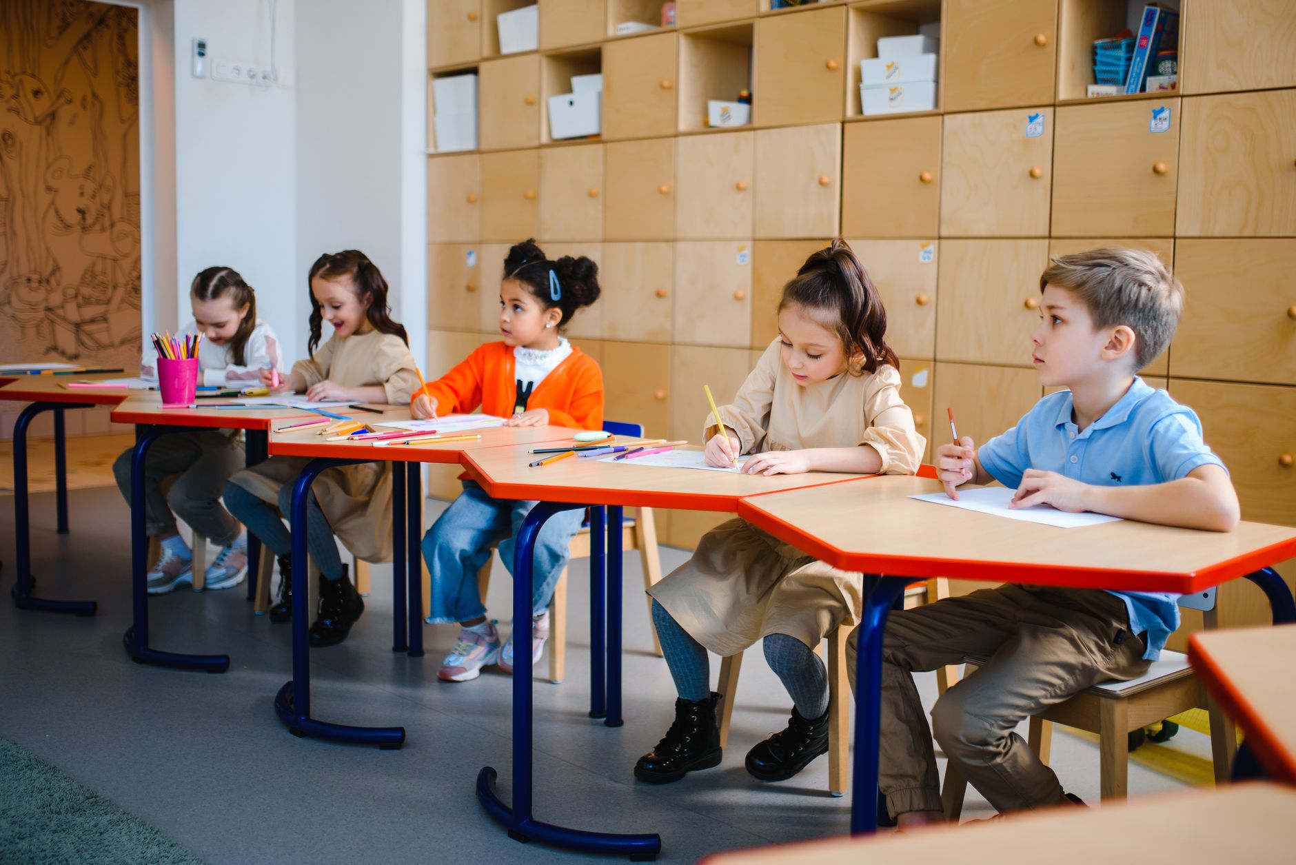 Preschool children seated together during a quiet group learning activity